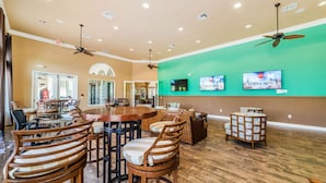 A spacious dining area with wooden tables and chairs, ceiling fans, and a green accent wall. - Aco7946ha - Bella Vida Resort - 6 Bed 5 Baths House (Kissimmee)