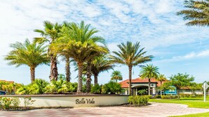 A landscaped area with palm trees and a building labeled "Bella Vida." - Aco7946ha - Bella Vida Resort - 6 Bed 5 Baths House (Kissimmee)