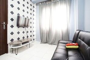 Room | Living room | 24-inch flat-screen TV with satellite channels, TV - City Park Apartment by Anita (Jakarta)
