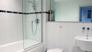 A modern bathroom with a glass-enclosed shower, a white toilet, and a sink. - 55 St James Walk (Cheltenham)