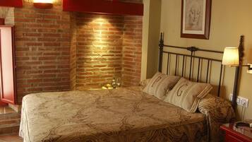 Cozy retreat with a brick wall, patterned bedspread, and metal headboard.