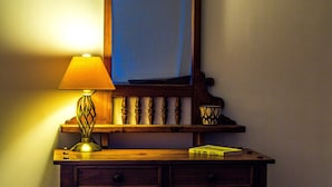 A wooden desk with a mirror, a lamp, and a book. - Hillbrook House Apartment 9 (Malvern)