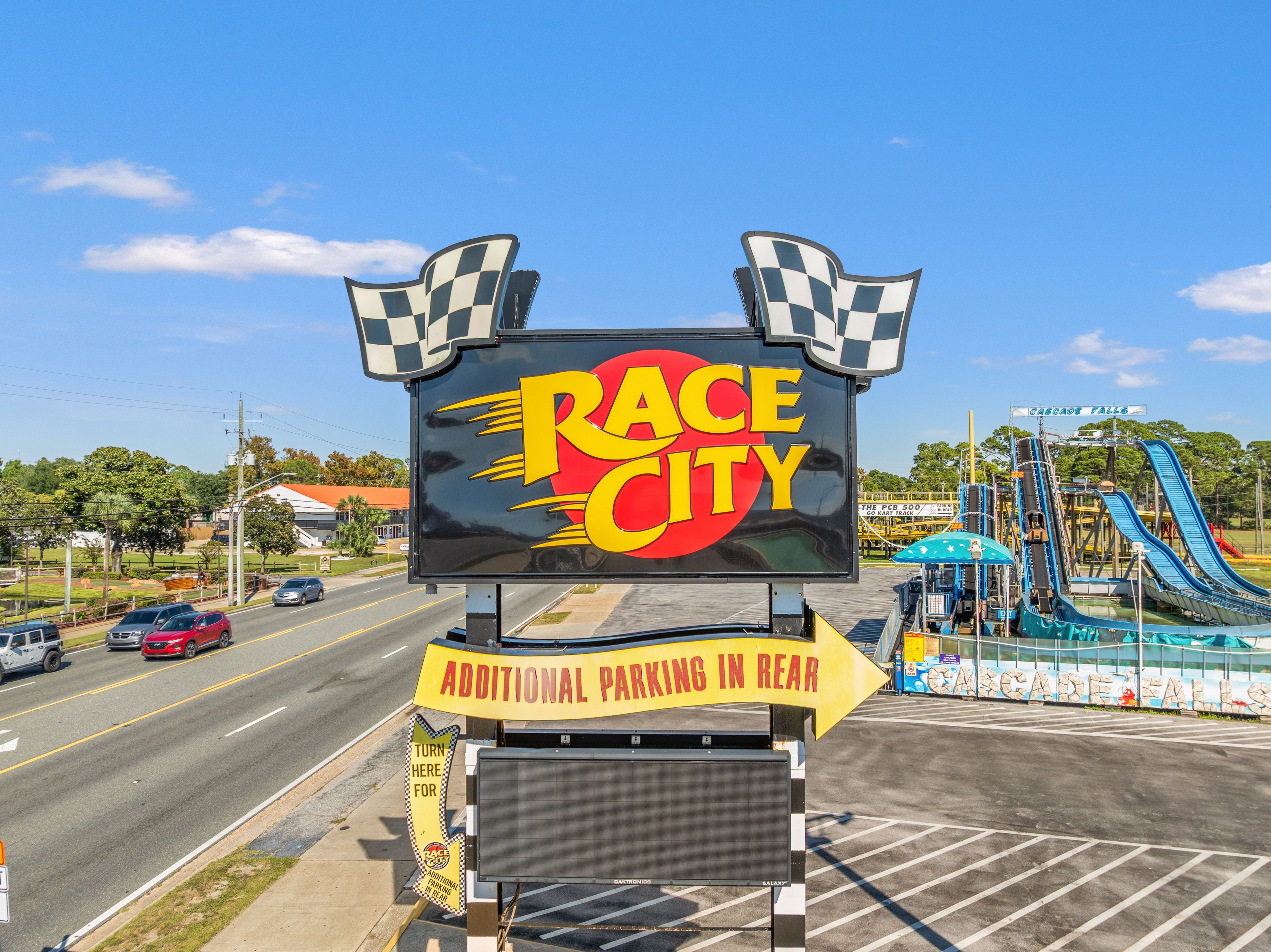 A sign for 'Race City' with a checkered flag design, indicating a racing theme.