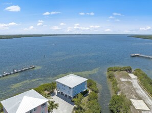 A coastal property with a large body of water, a pier, and a small dock. - Townhome with stunning view of Matlacha Pass (Matlacha)