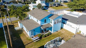 A two-story house with a front porch, a small deck, and a garage. - Private Beach House - 1 Block From The Beach + Free Attraction Tickets! (North Myrtle Beach)