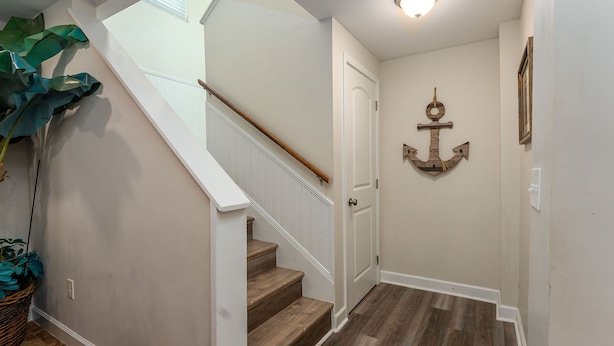 A staircase with wooden steps and a white handrail, leading to a door. - Private Beach House - 1 Block From The Beach + Free Attraction Tickets! (North Myrtle Beach)
