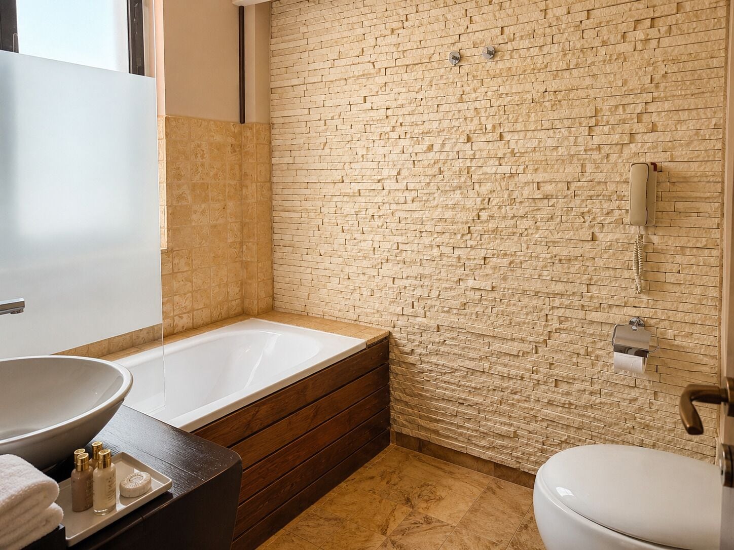 A bathroom with a bathtub, a sink, and a toilet.