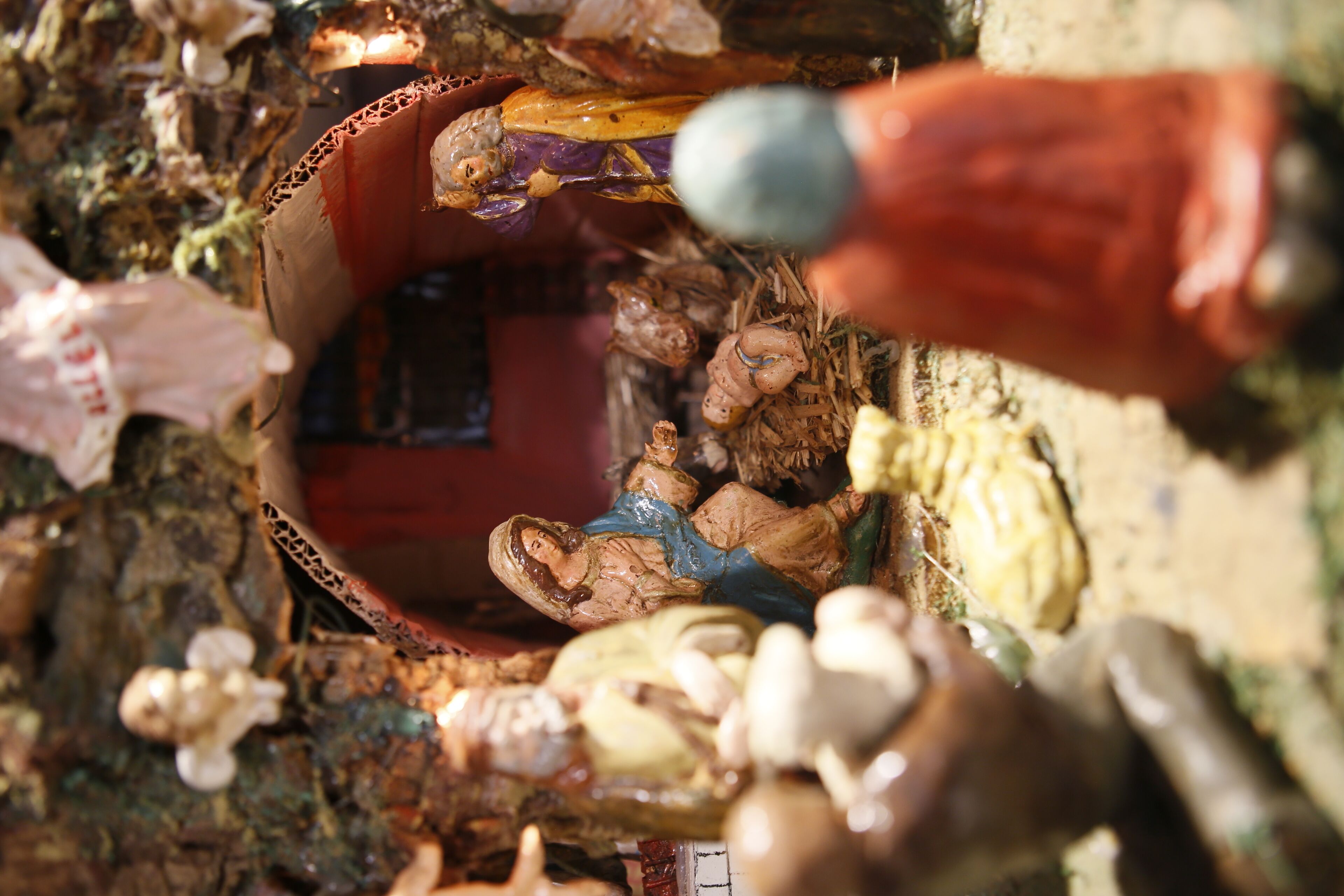 A close-up of a rustic, cluttered interior with various objects and a small, ornate wooden chest.