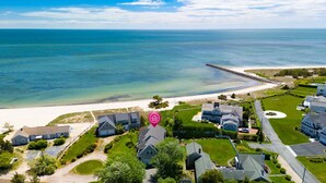 A coastal residential area with houses, a beach, and a pier. - Gorgeous home sleeping 12 with ocean views (West Harwich)