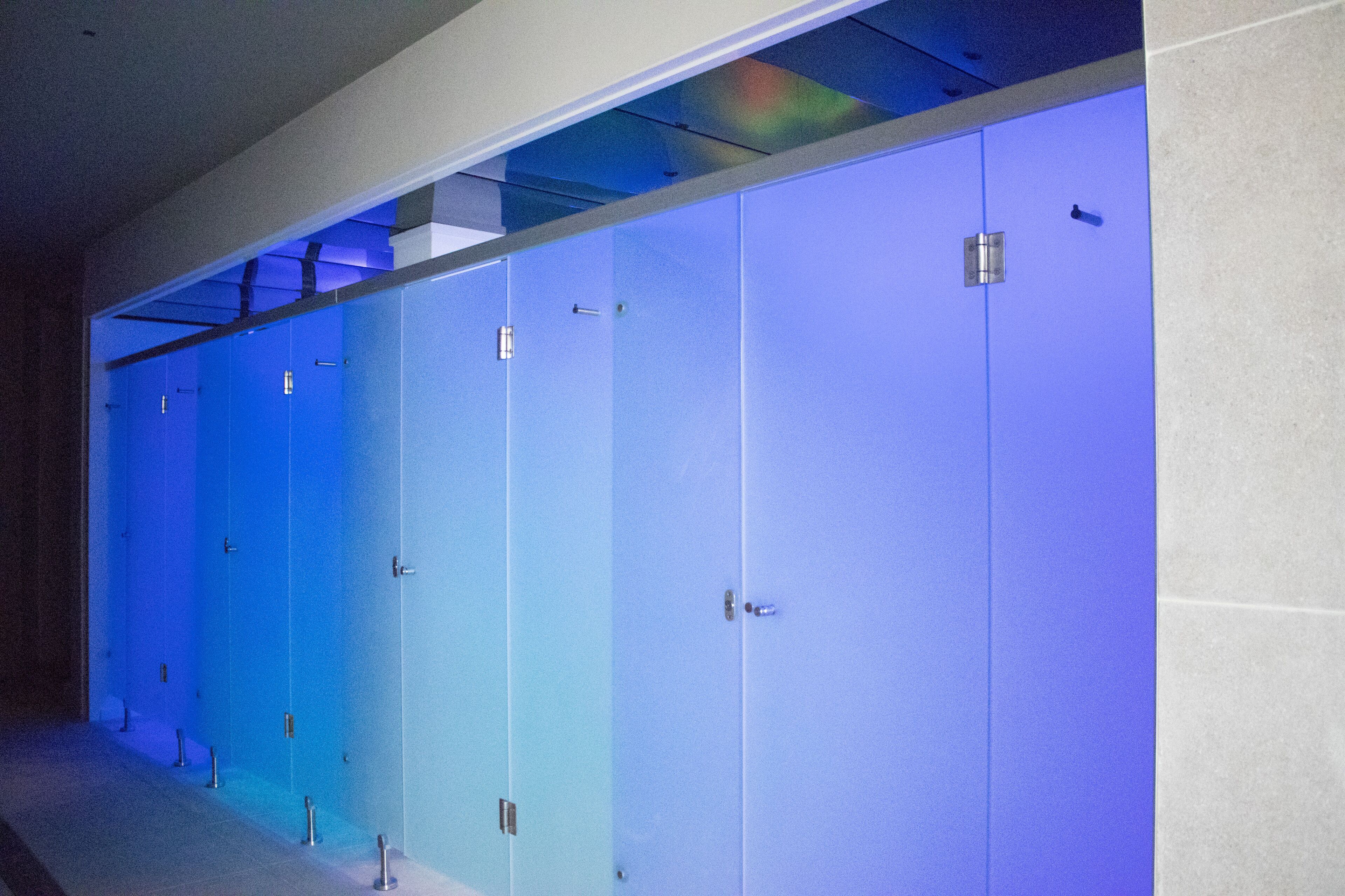 A row of blue lockers in a hallway.