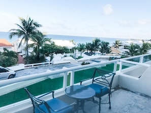 Enjoy a serene ocean view from this balcony, perfect for relaxation or dining.
