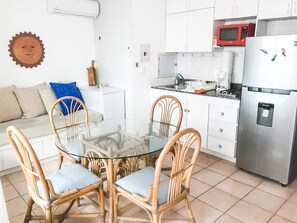 Enjoy meals at the glass-top dining table surrounded by four chairs.