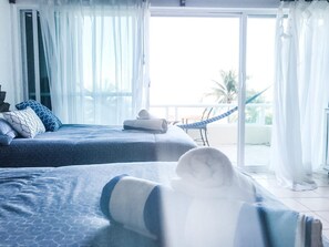 Relax in comfort with two beds and a hammock nearby, offering a serene escape.