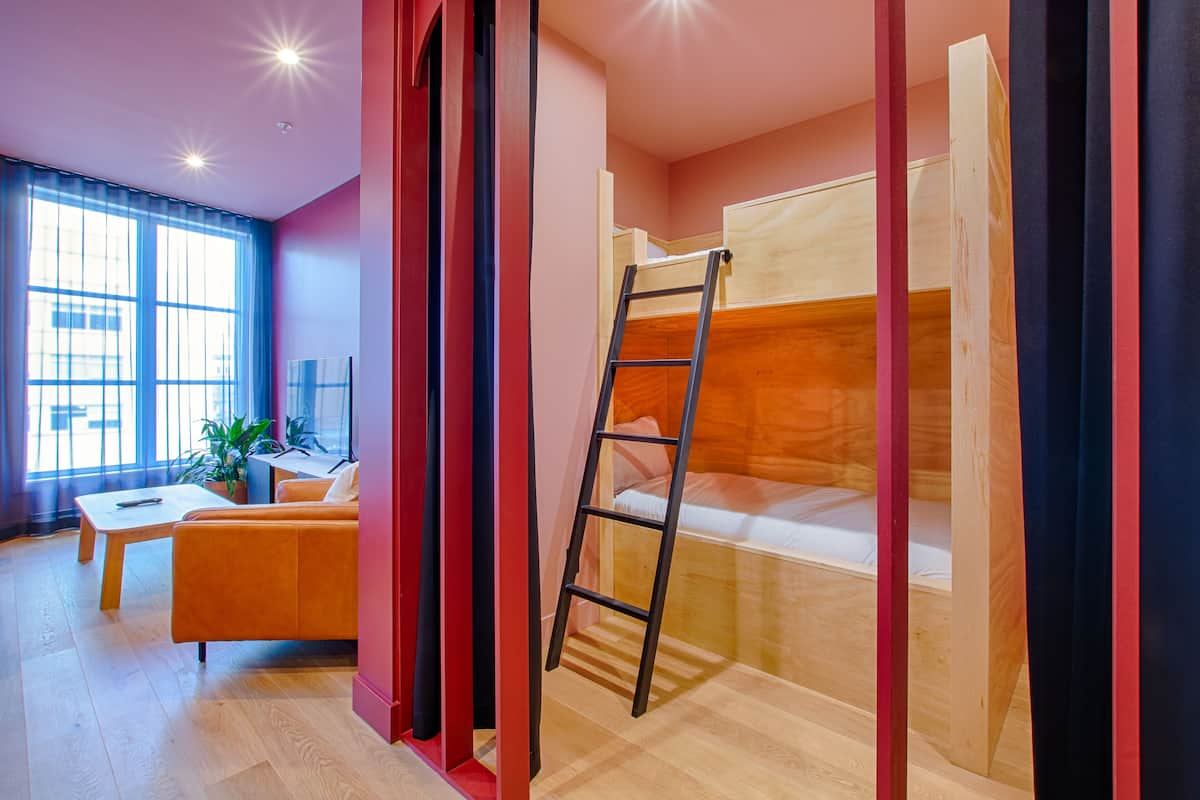A modern room with a bunk bed, a desk, and a chair.