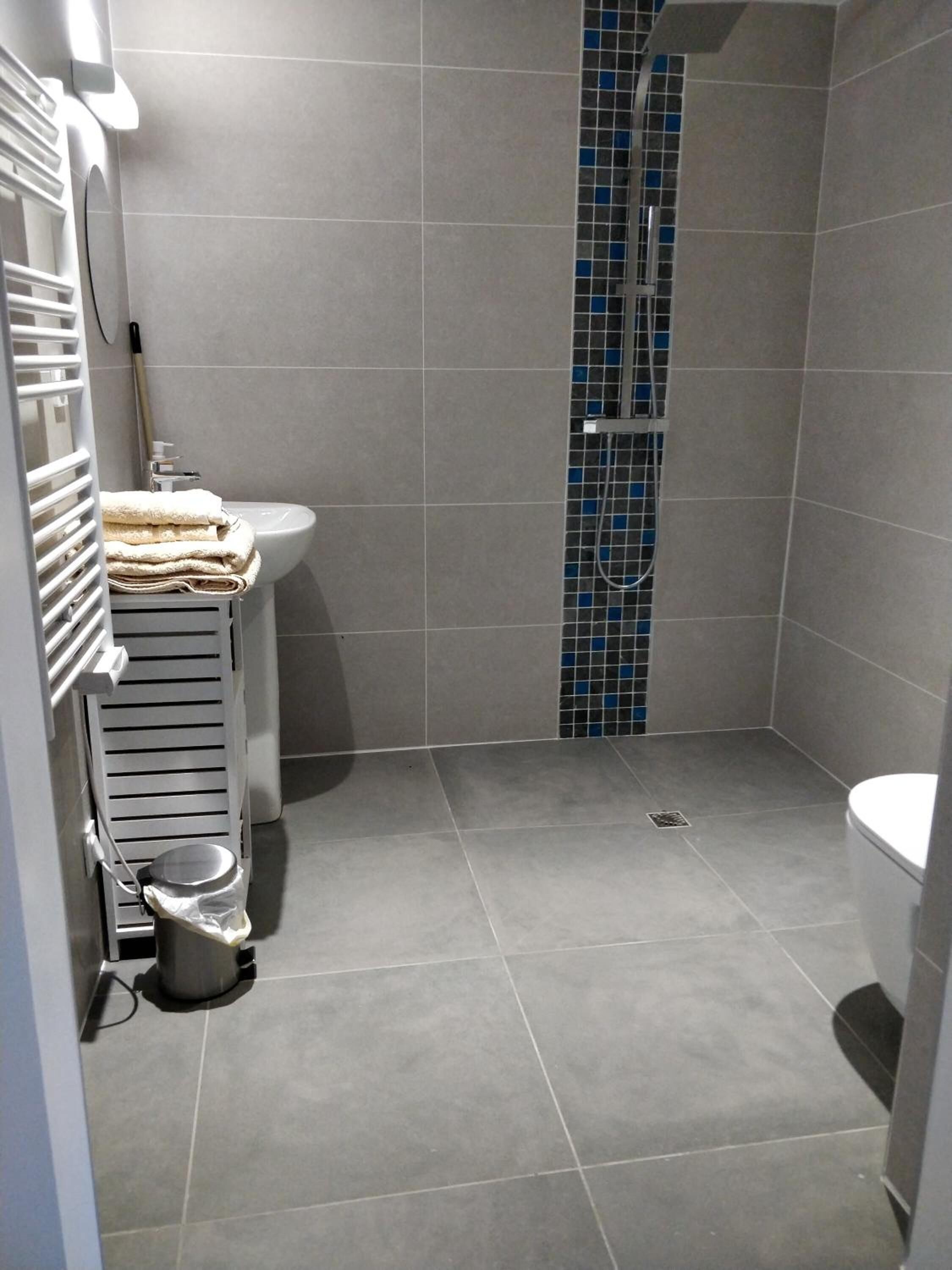 Shower, rainfall showerhead, hair dryer, towels