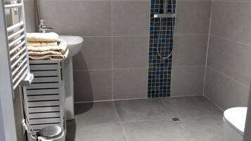 Shower, rainfall showerhead, hair dryer, towels