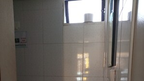 A small, basic bathroom with a toilet, sink, and a window. - Callao Backpacker - Adults Only (Callao)