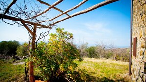A rustic stone building with a wooden pergola structure. - Secluded location and absolute tranquility in Tuscany (Monticello Amiata)