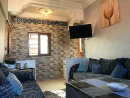 Apartment, 1 Bedroom | Living room | 32-inch flat-screen TV with satellite channels, TV