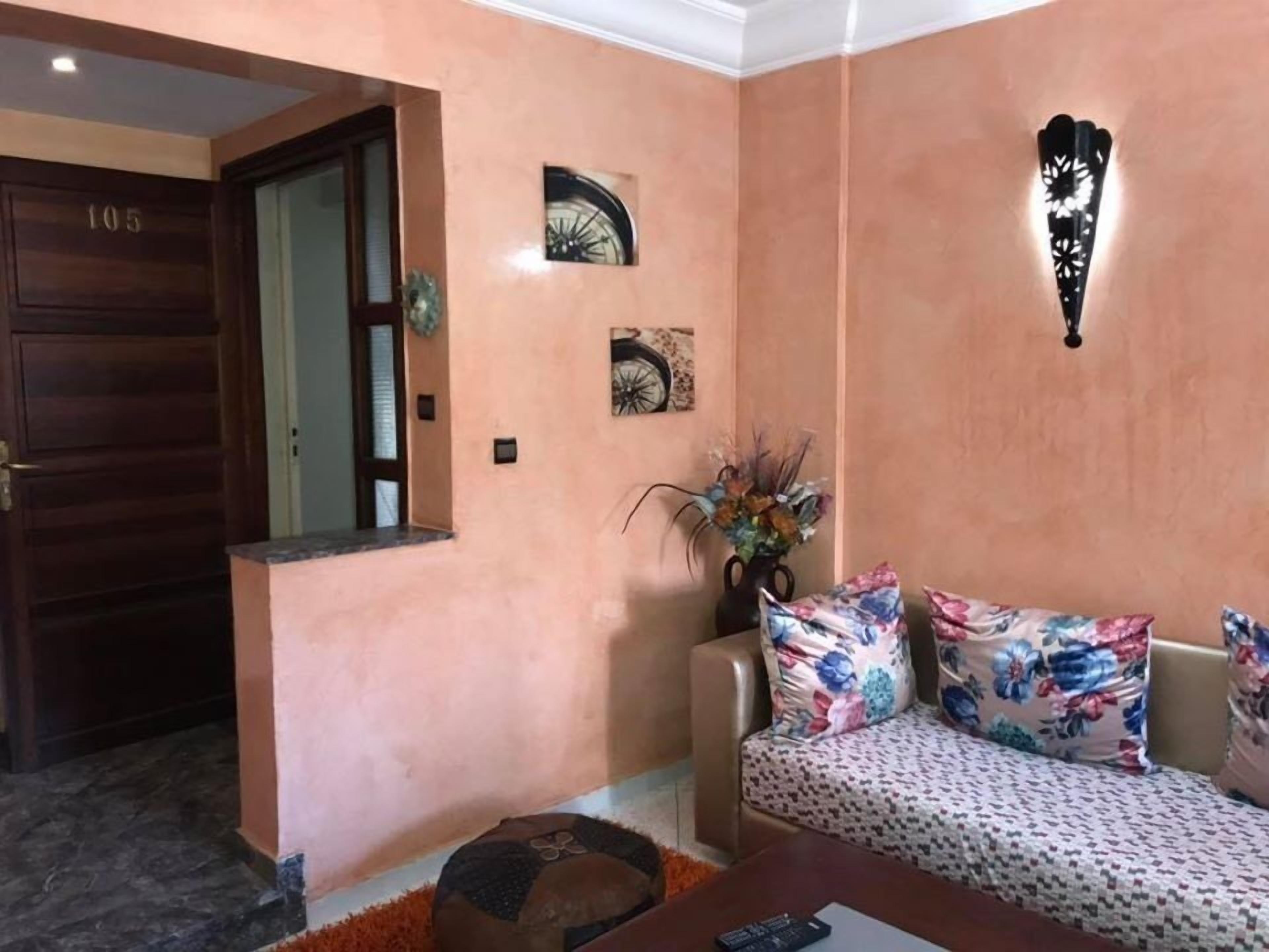 A living room with a sofa, a coffee table, and a decorative wall piece.