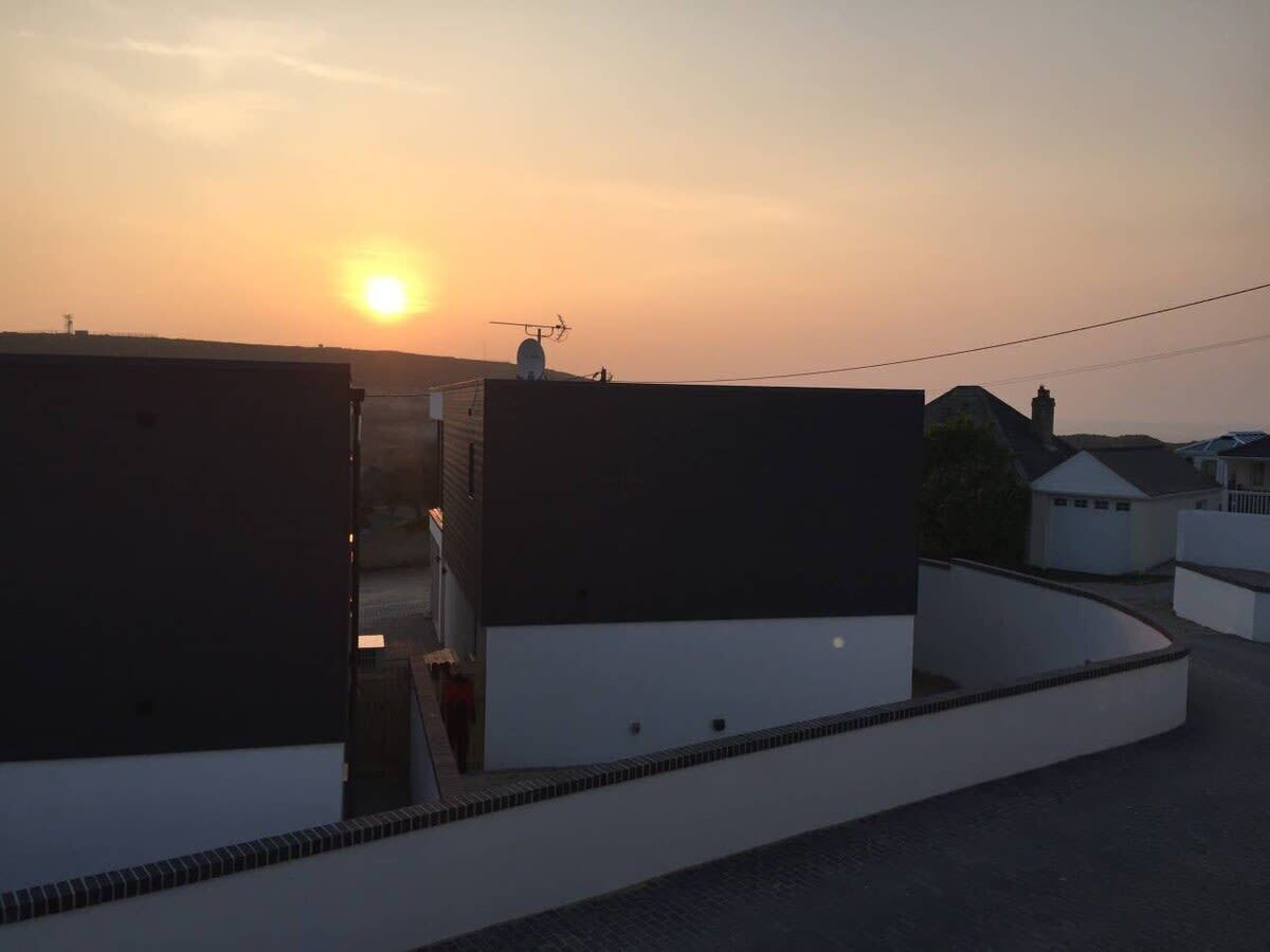 A residential area with modern buildings during sunset.