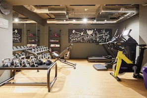 A gym with kettlebells, a bench press, and treadmills. - Moxy Bucharest Old Town (Bucharest)