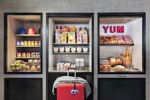 A display of breakfast items including cereals, pastries, and dairy products in a store. - Moxy Bucharest Old Town (Bucharest)