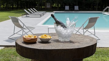 Seasonal outdoor pool, open 8:30 AM to 8:00 PM, pool loungers