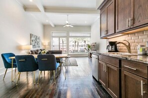 Enjoy meals in the kitchen with oven, microwave, and coffee maker, and dine at the wooden table with four chairs.
