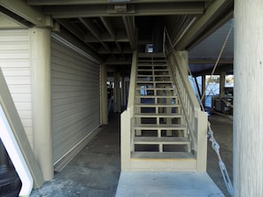 A covered outdoor staircase leading to a building entrance. -  Wake up to the Surises and soothing sound of waves in this ocean front condo. (North Myrtle Beach)
