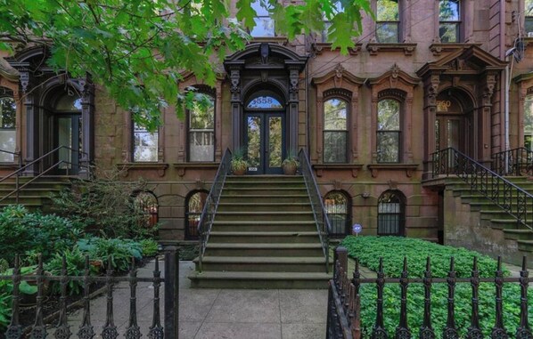 Step into grandeur at this historic building, featuring a stately entrance with a large door and ornate details.