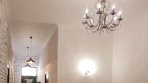 A living room with a sofa, armchairs, a chandelier, and a potted plant. - Green flower is located in the historical part of Kutaisi.5-minute walk  centre. (Kutaisi)