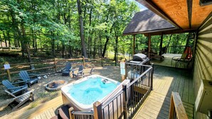 A wooden deck with a hot tub, Adirondack chairs, and a barbecue grill. - Blue Pine Lodge  - w/ Hot Tub - What a Mountain Cabin Should Be! (McGaheysville)