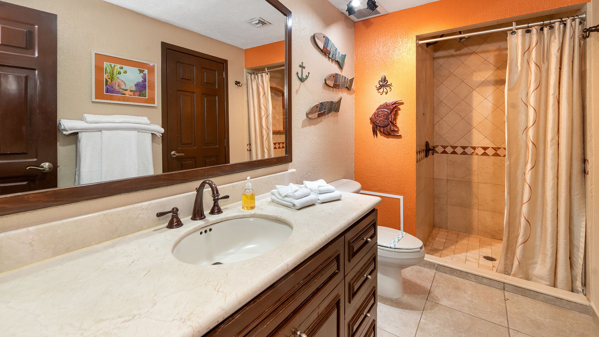 Un baño con lavabo, espejo y ducha.