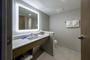 A modern bathroom with a large mirror, dual sinks, a towel rack, and a toilet. - Holiday Inn Express & Suites Staunton by IHG (Staunton)