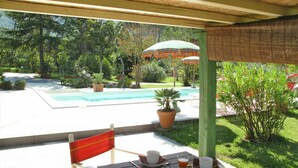 An outdoor dining area with a table set for breakfast, overlooking a swimming pool and lush greenery. - Stunning private villa with private pool, WIFI, A/C, TV, terrace, pets allowed and panoramic view (Camaiore)