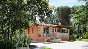A small house with a stone facade, a tiled roof, and a porch with a railing. - Stunning private villa with private pool, WIFI, A/C, TV, terrace, pets allowed and panoramic view (Camaiore)