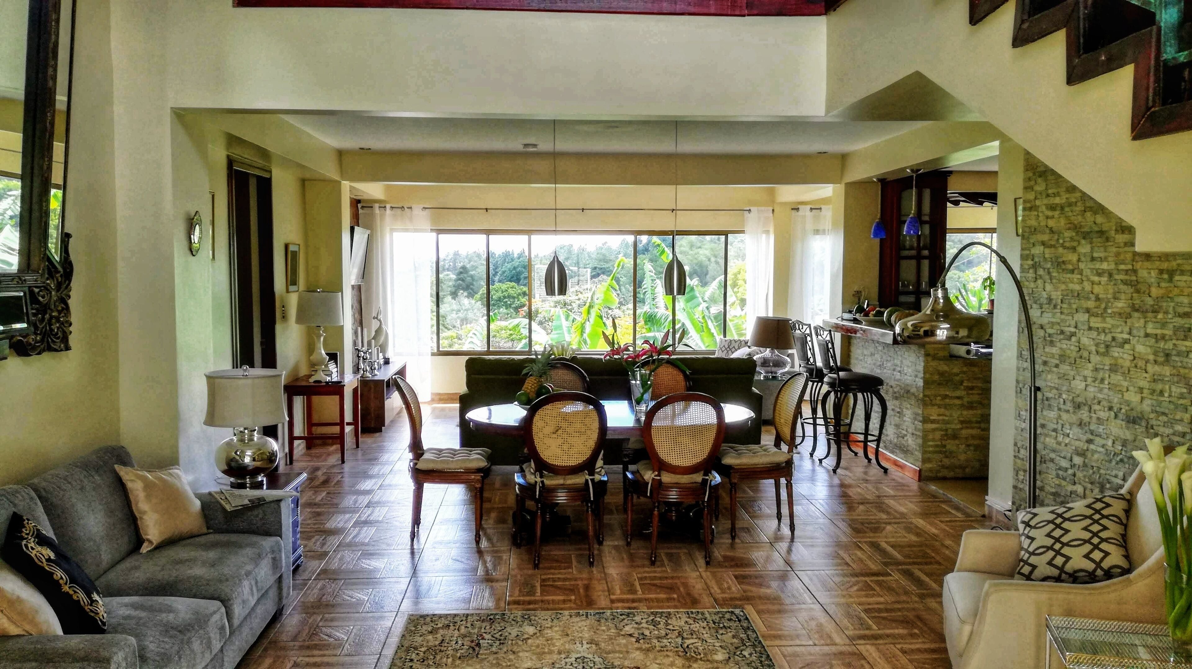 A spacious living room with a dining area, a sofa, and a coffee table.