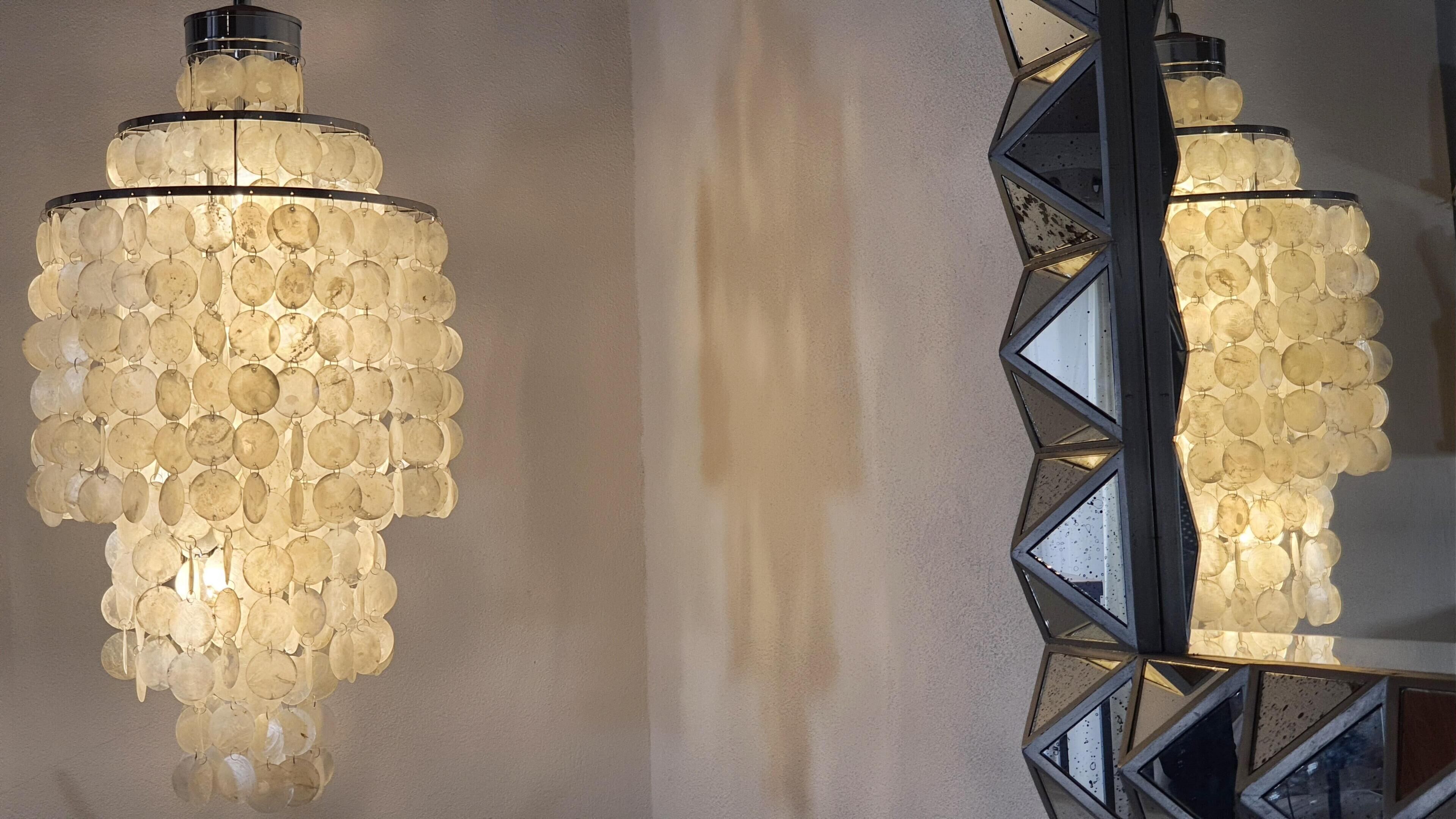 A chandelier with multiple tiers of clear glass bulbs.