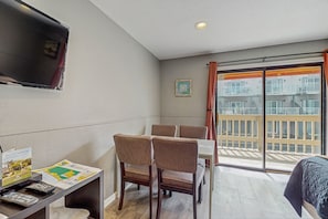 Enjoy a meal at the dining table with four chairs, or relax on the balcony with a view of the building's exterior.