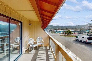 Enjoy the view of the city and distant mountains from this room's balcony.