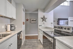 Enjoy cooking in this well-lit kitchen with oven and microwave.