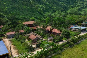 A rural village with several houses surrounded by dense greenery. - Lan Homestay (Hai Phong)
