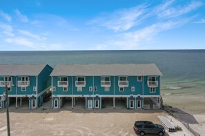 A beachfront hotel with multiple rooms, a parking area, and a view of the ocean. - Beachfront, Corner Unit, North Cape San Blas - Pelican Crossing (Cape San Blas)
