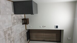 A modern bathroom with a dark wood vanity, a wall-mounted light fixture, and a tiled backsplash. - apartments are located in a quiet area near the park. there are 2 restaurants (Lviv)