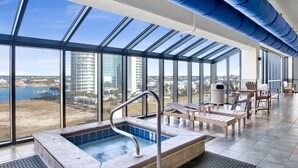 A rooftop pool area with a view of the city and water body.