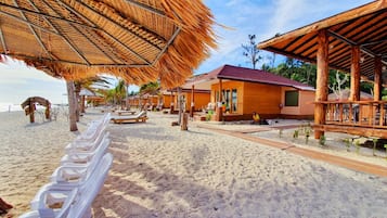 On the beach, white sand, beach umbrellas, beach towels
