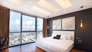 A spacious bedroom with a large bed, a city view, and modern decor. - Tower Sea View Luxury 32 Floor Apartment (Tel Aviv)