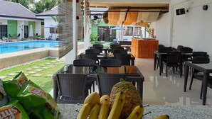 A restaurant with outdoor seating, a pool, and a bar area. - Chinita Boutique Hotel (Dauis)
