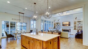 A spacious kitchen with wooden cabinets, a large island, and pendant lighting. - 85 Mooring Buoy -Dock, Private Pool & Lagoon Views. 176 Yards to the ocean (Hilton Head Island)